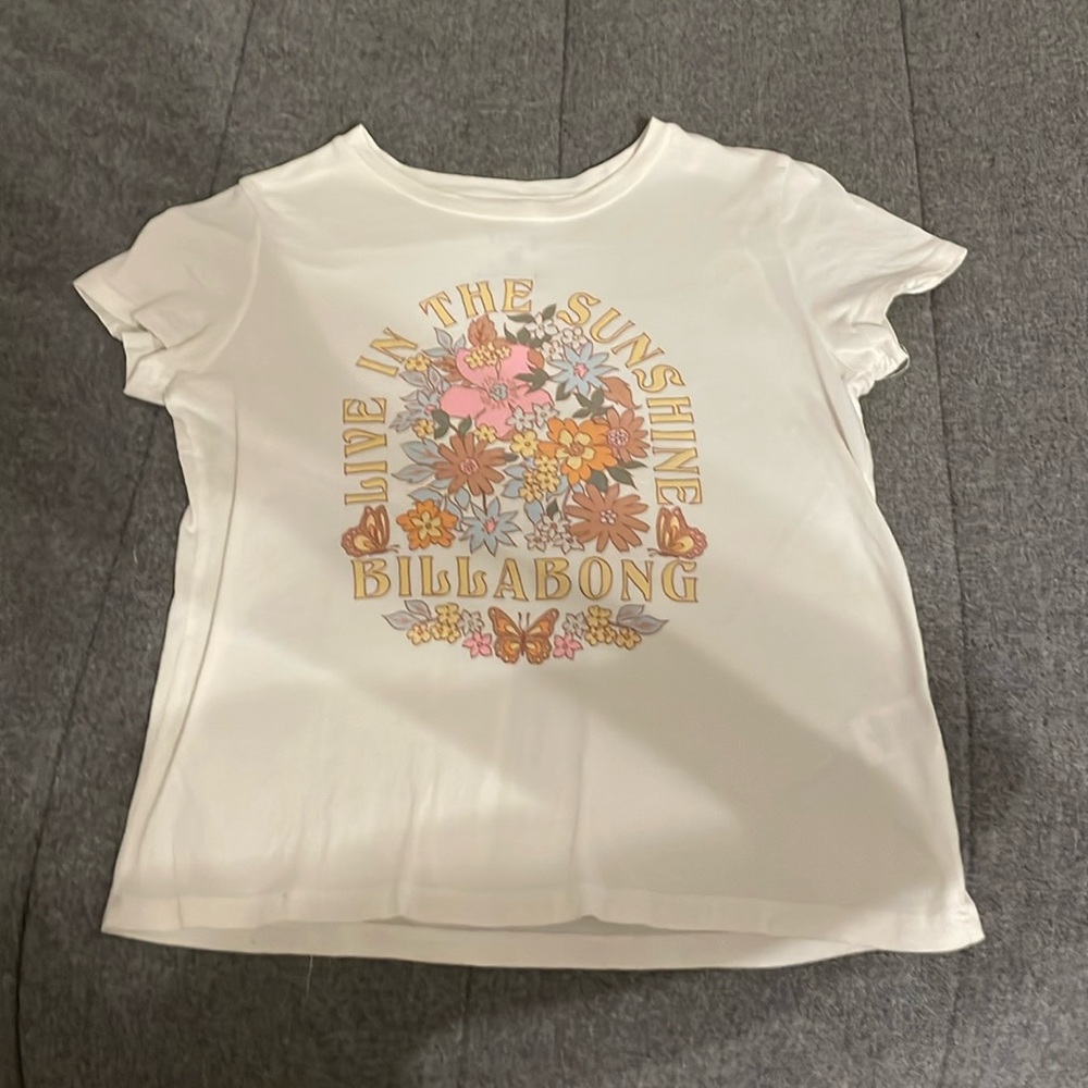 cream colored t-shirt with billabong writing